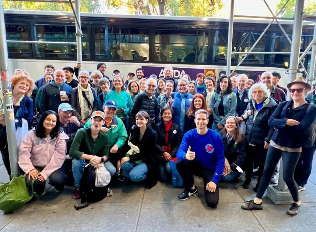 Volunteers standing next to a bus